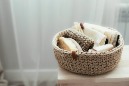 Woman folding clothes in jute basket in the konmari system. Concept of organizing minimalism...