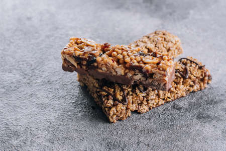 Granola bar. Healthy snack. Cereal granola bar with nuts, chocolate on concrete table background. Top view with copy space.の写真素材