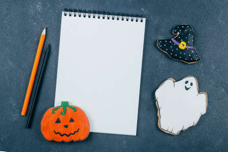 Morning Breakfast Halloween Fall Autumn Concept. Pumpkin gingerbread cookie and cup of black coffee on wooden rustic background. Top viewの写真素材
