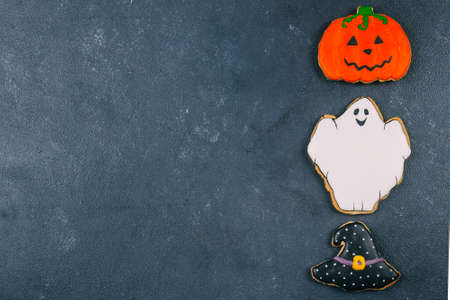 Morning Breakfast Halloween Fall Autumn Concept. Pumpkin gingerbread cookie and cup of black coffee on wooden rustic background. Top viewの写真素材