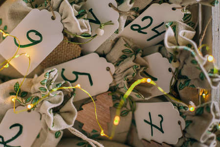 Top view of wooden box with fabric eco bags with number. Concept of kids christmas advent calendarの写真素材