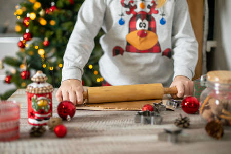 Preparation of festive christmas gingerbread cookies. Raw dough, cutting cookie and holiday decorationの写真素材