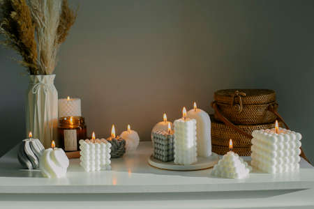 home decor. White dresser with dried flowers in vase, rattan bags and candles. Still life, hygge conceptの写真素材