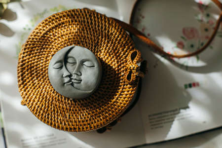 Gray candle in the shape of moon and sun. top view.