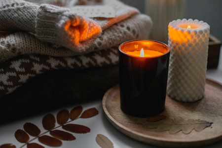 Woman drinking tea and a reading book. Cozy autumn at home.の写真素材