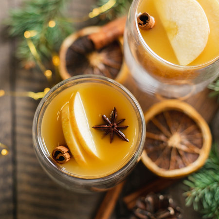 Hot apple cider with cinnamon sticks, apple and holiday christmas decoration. Top view. Banner image for design.の写真素材