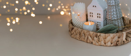 Cozy burning candles and festive decor. Winter mood. Cozy home decor. Festive decoration. Long...