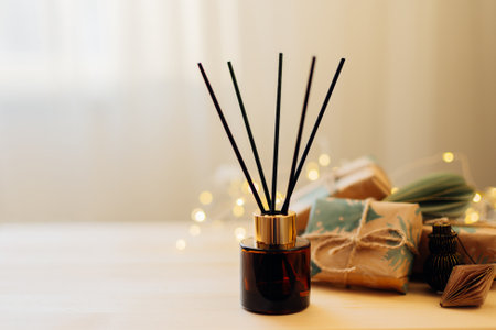 Home winter aroma fragrance diffuser on wooden table. Interior elements. Christmas and Winter decoration. Copy spaceの写真素材