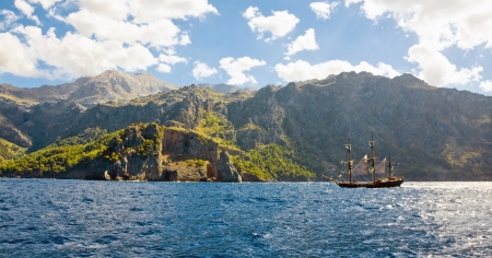 the amazing and wild coastline of Majorca island with a pirate ship, from movie  Atlas Cloud の写真素材