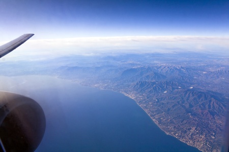 View from plane on the clounds and earth underの写真素材