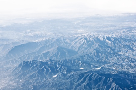 View from plane on the clounds and earth underの写真素材