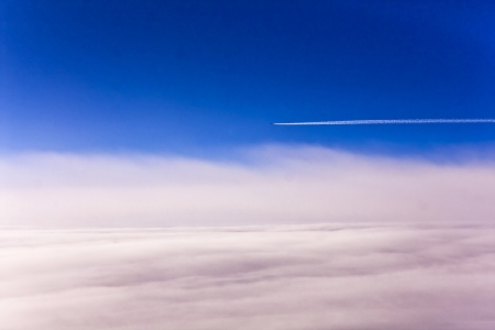 View from plane on the clounds and earth underの写真素材