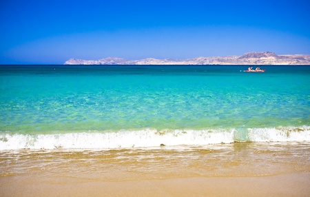 Sea bay with moored boats, promenade in Mediterranean town Sitia Greece Crete
