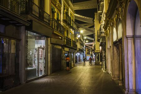 Narrow street in Seville at night, Spainの写真素材