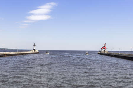 Duluth, Minnesota   June 20, 2013 North and South Piers and Lighthouses at the entrance in Canal Park to Duluth Harbour のeditorial素材