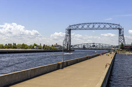 Duluth, Minnesota - June 20, 2013   The Aerial Lift Bridge is a major landmark in the port city of Duluth, Minnesota  The bridge spans the Duluth Ship Canal, which was put through the thin but long sand spit named Minnesota Pointのeditorial素材