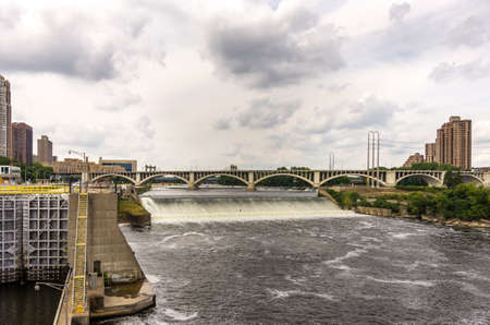 minneapolis, Minnesota - August 21, 2014: The old historical St. Anthony Falls upper lock and dam at the Mississippi river alongside the Mill City Ruins in Minneapolis, MN, USAのeditorial素材