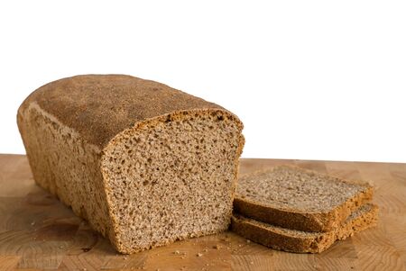 Fresh homemade tin bread with 2 slices on a cutting boardの写真素材