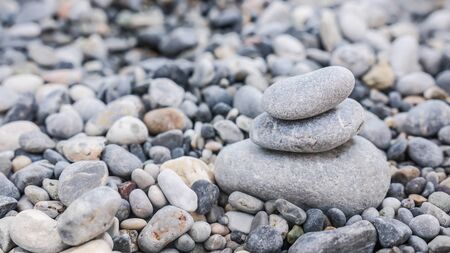 Small tower made of pebbles on a rocky beachの写真素材