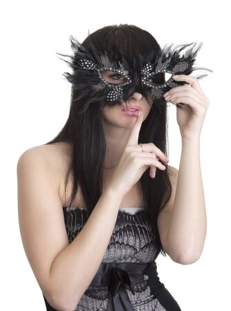 Beautiful woman with mask and finger near lipsの写真素材
