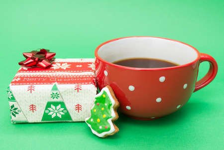 A cup of coffee, Christmas cookie and a presentの写真素材