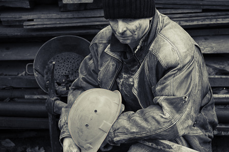 A loaf of bread in an old mans handsの写真素材