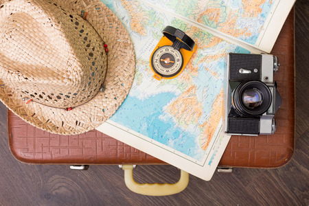 Vintage travel suitcase with map and compassの写真素材