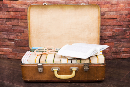 Books in a vintage suitcase. Retro look image with added textureの写真素材