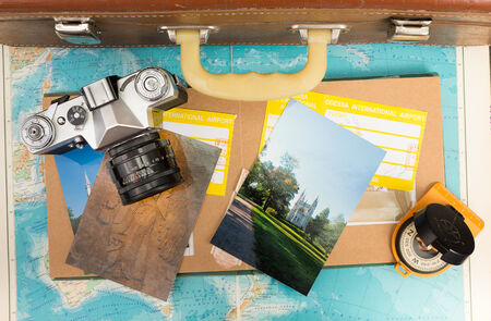 Vintage travel suitcase with map and compassの写真素材