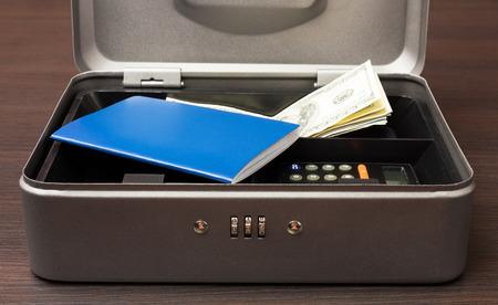 Steel cashbox with documents and moneyの写真素材