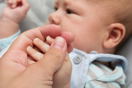 Father holding babyâ€™s hand