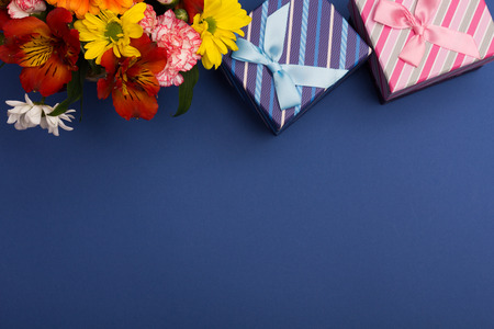 Beautiful flowers and gift box with ribbonの写真素材