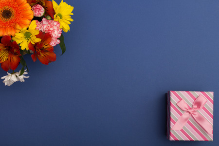 Beautiful flowers and gift box with ribbonの写真素材