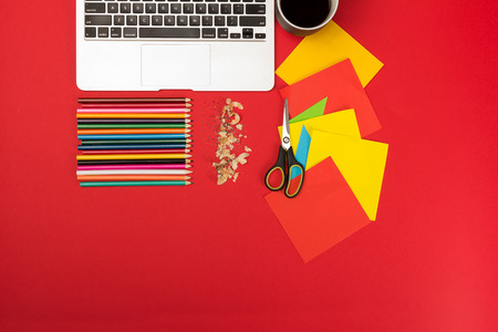 Creative messy workplace with laptop and stationeryの写真素材