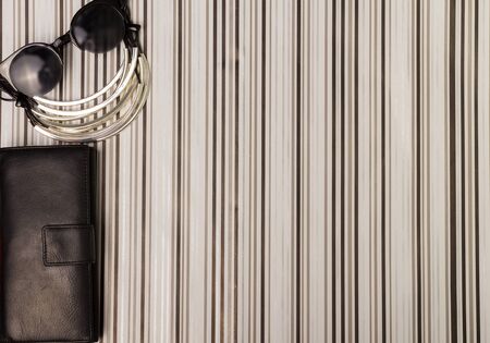 Sunglasses, necklace, purse and a bottle of perfumesの写真素材