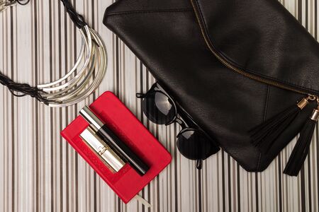 Sunglasses, necklace, purse and a bottle of perfumesの写真素材