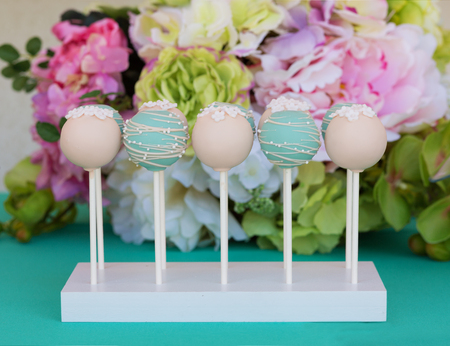 Various tasty candies on a stick with frostingの写真素材