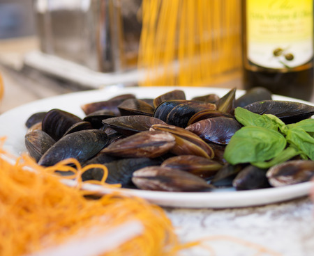 Cooking pasta and mussels in the street food festivalの写真素材
