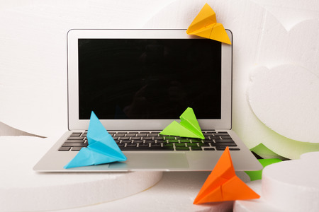Creative artistic workplace with a laptop and notebook