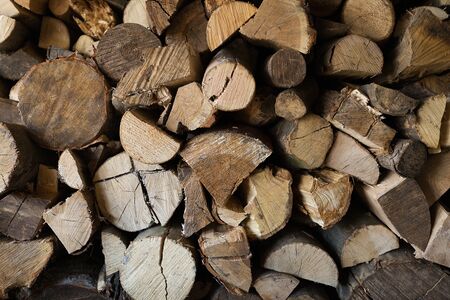 Piles of firewood in a storage. Abstract background