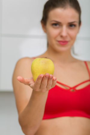 Beautiful woman holding an apple in her handの写真素材
