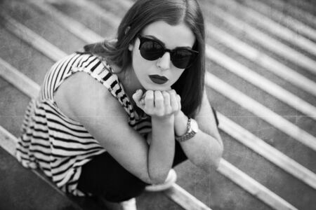 Lonely girl on the stairs. Black and white imageの写真素材