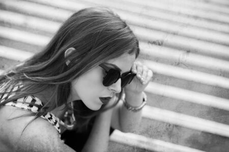 Lonely girl on the stairs. Black and white imageの写真素材