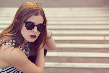 Lonely girl standing on the stairs. Toned imageの写真素材