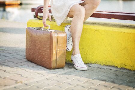 Young woman with a suitcase ready for a summer vacationの写真素材