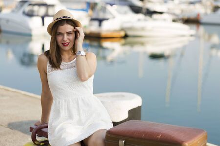 Young woman with a suitcase ready for a summer vacationの写真素材