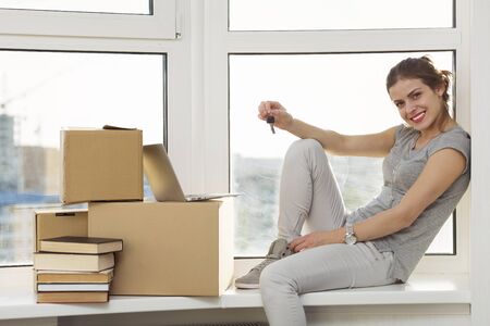 Beautiful girl moving in the new apartmentの写真素材