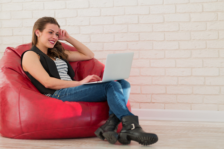 Stylish woman working at the laptop at her homeの写真素材