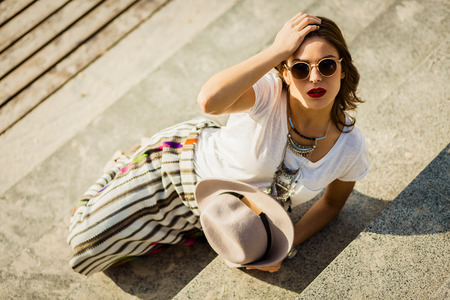 Stylish boho girl in summer cityの写真素材