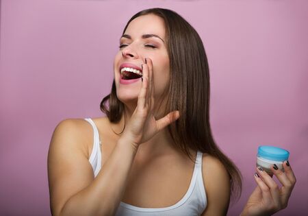 Pretty woman holding a skin care productの写真素材